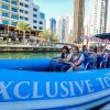 Xclusive Yachts Speed boat cruising through Dubai Marina with stunning views of the skyline, available to book through El Camino Travel.