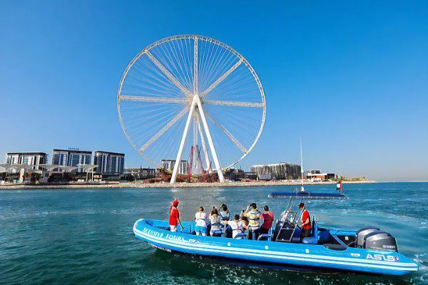 Xclusive Yachts Speed boat cruising through Dubai Marina with stunning views of the skyline, available to book through El Camino Travel.